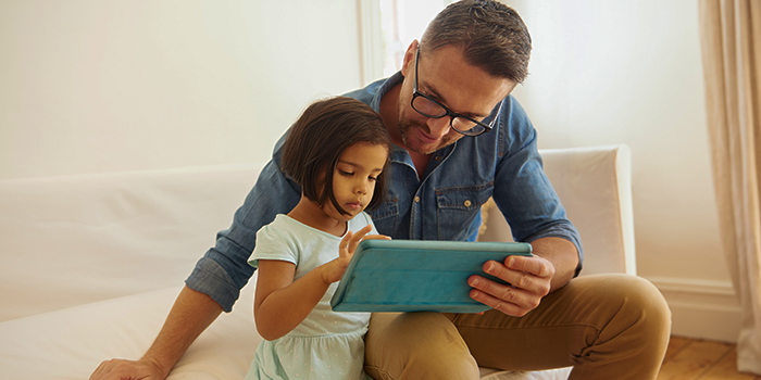 Padre e figlia che guardano contenuti multimediali su ipad